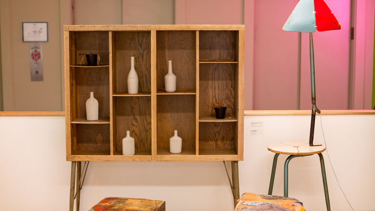 Wooden shelving and a chair with a lamp