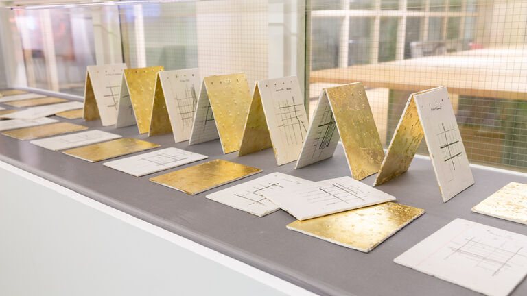 Folded cards with gold plating on some of them.