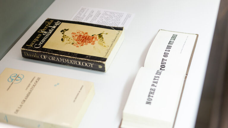 Two books placed on a white surface.