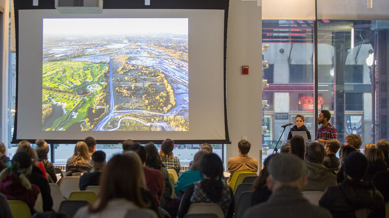 A large group of students looking at a projector.