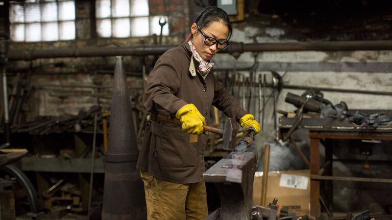 A sculpture student working in the metal shop