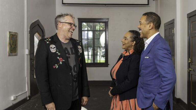 Three people speaking in a room