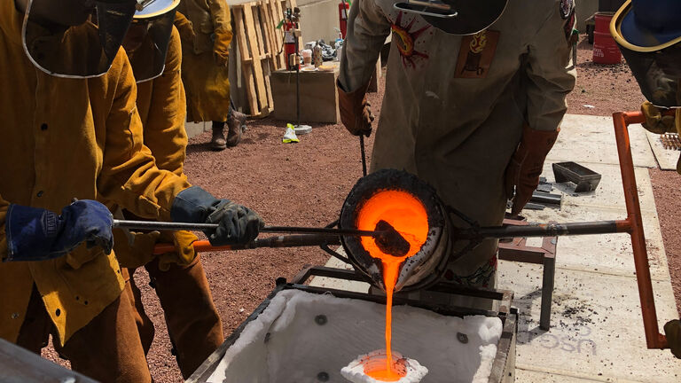 Students pouring iron outside the 280 building