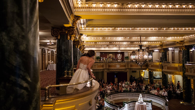 View of a populated ballroom from a balcony