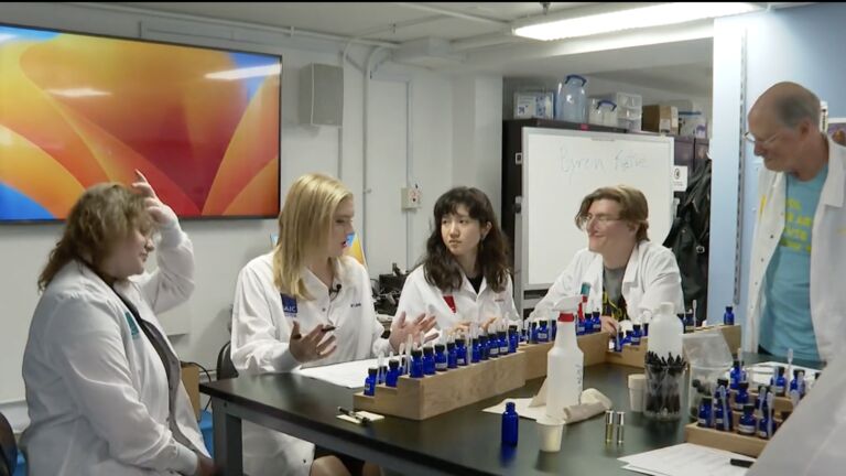 SAIC students experimenting with scents to create unique artworks in a classroom setting.