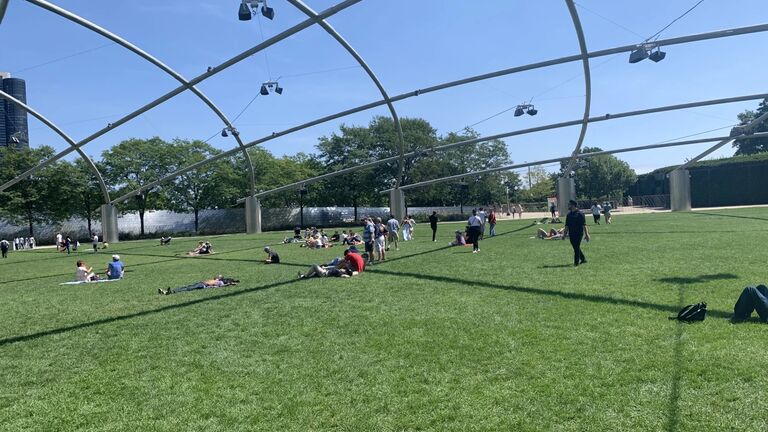 An image of the Pritzker Lawn of viewers engaging with the sound installations.