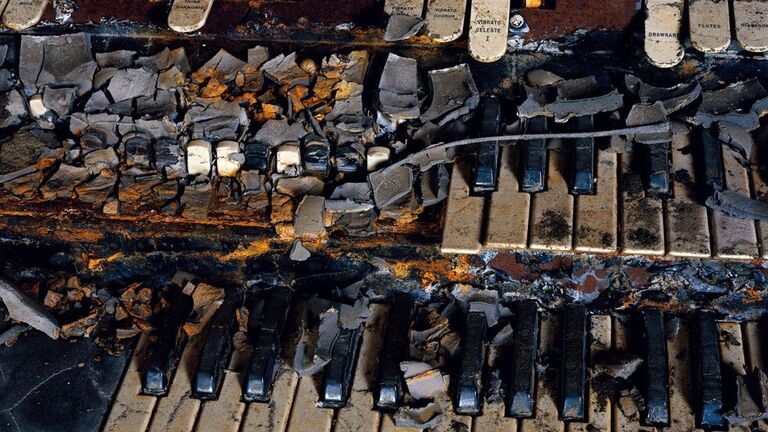 Close up of a piano after Hurricane Katrina which resembles a cemetery.