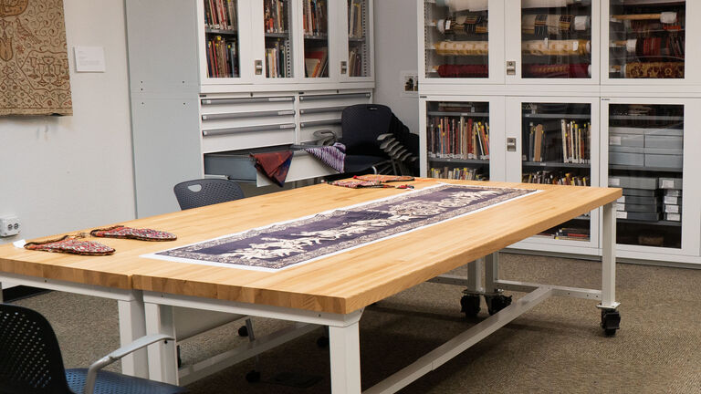 Resource space with a table, chairs, and shelving units