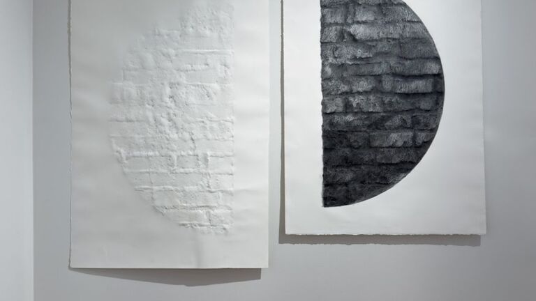 Two half-circles across two sheets of paper, facing each other