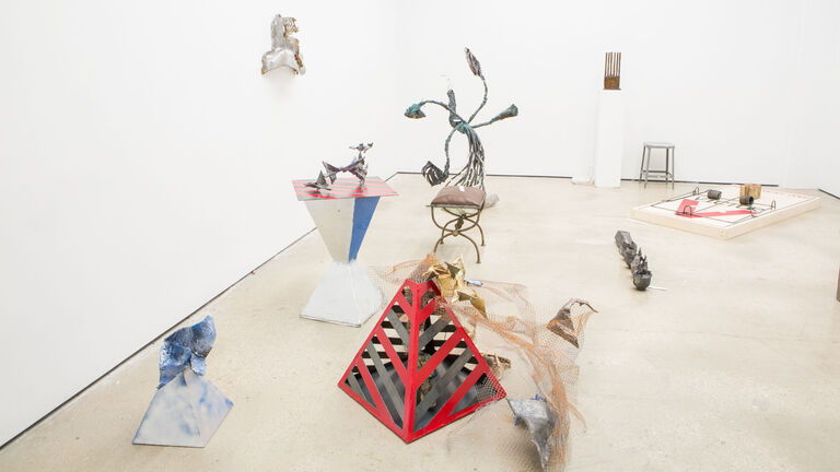 A picture of geometric sculptures on display in a gallery setting