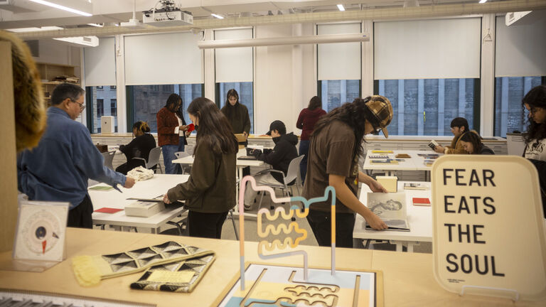 A photo of multiple students at the SAIC library.