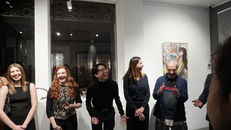Mechtild Widrich and Lou Mallozzi stand in the gallery with students