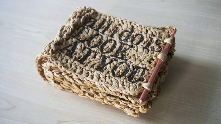 A woven book cover that says "All I do is look at you."