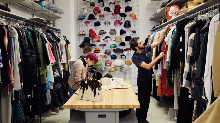 Two people viewing items in the Fashion Resource Center. 