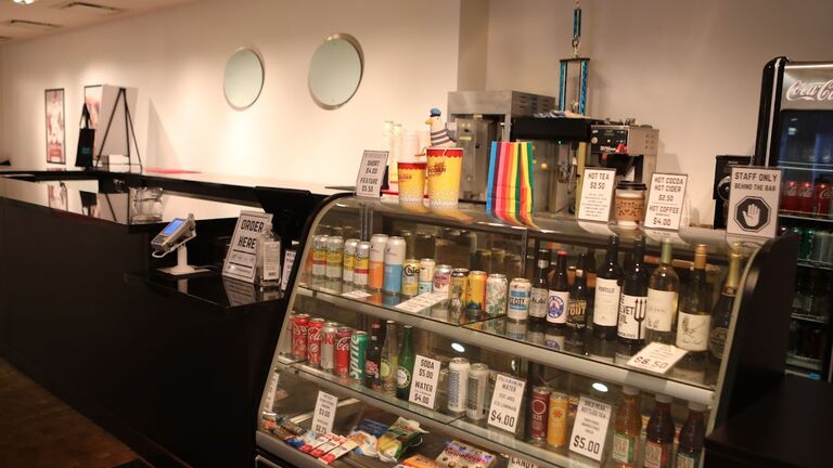 A glass concession stand inside a movie theater.