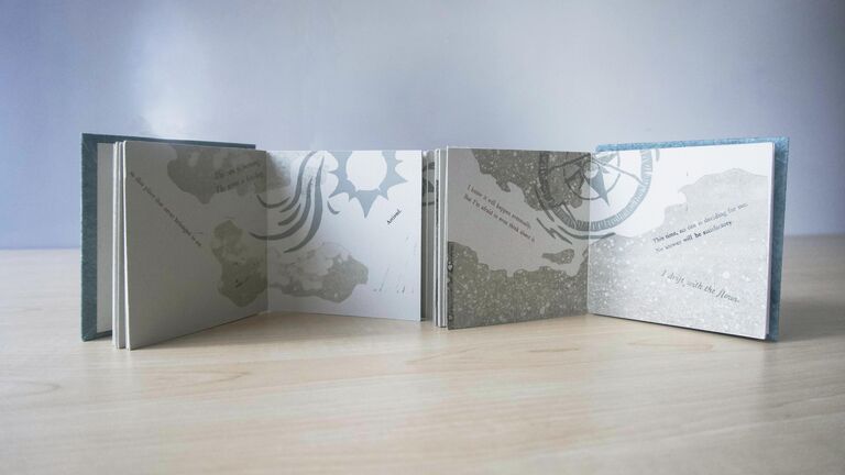 A book with accordion pages unfolded.