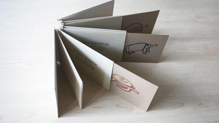 A book with pulled out pages illustrated with turtles.