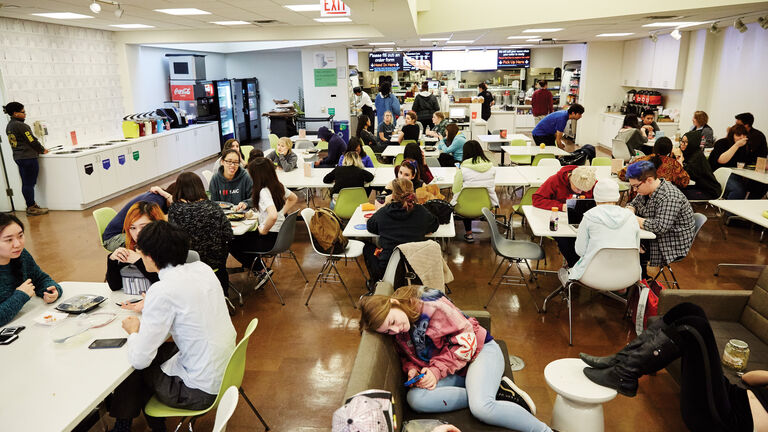 Students of varying ethnicities and genders gathered in a cafeteria. 