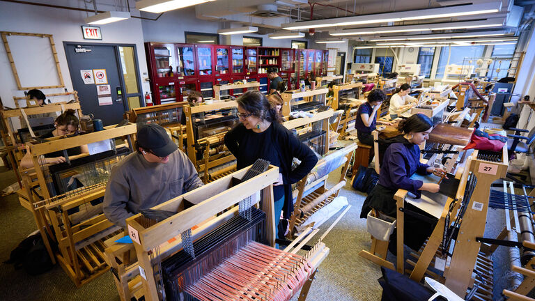 Students working in a fibers classroom. 