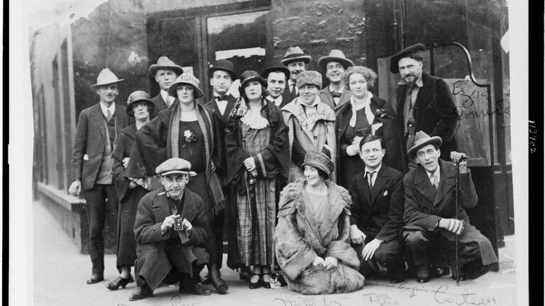 Ezra Pound, Tristan Tzara, Man Ray, Kiki Ray, Mina Loy, Jane Heap, Jean Cocteau, Martha Dennison and others in front of the Jockey Club of Paris, 1923.