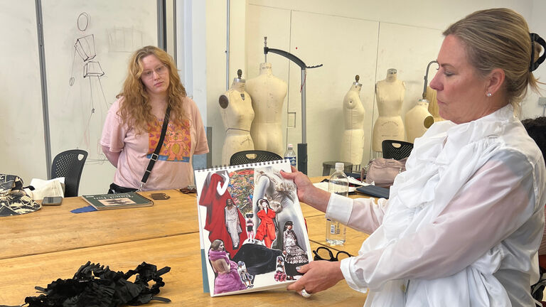 A Continuing Studies student shows off their work in a fashion class.