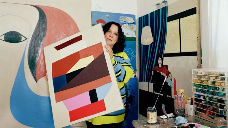 Clare Rojas holding a painting