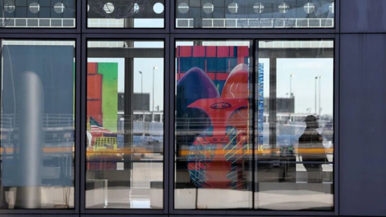 An image of Chicago's Picasso sculpture on display in a window at O'Hare International Airport 