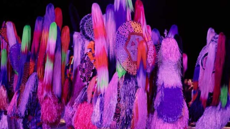 Performers dancing, dressed in Nick Cave’s large Soundsuits in “Up Right” at the Park Avenue Armory.