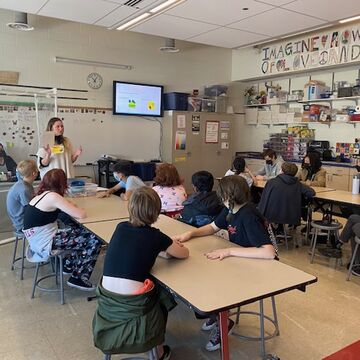 A teacher speaking to a class.