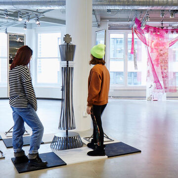 Students observe a piece in the SAIC galleries.