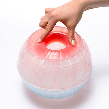 Image of a hand touching a spherical glass object.