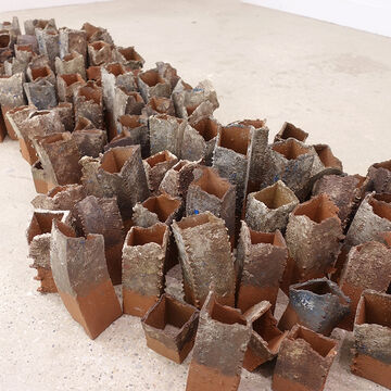 A bunch of rectangular sculptures, grouped together like barnacles