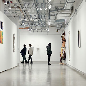 An image of students in a large, open gallery space.