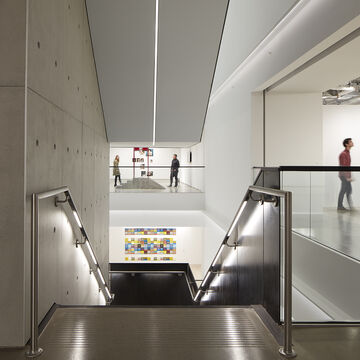 iew of SAIC Galleries open stairwell with patrons viewing artwork and walking around galleries