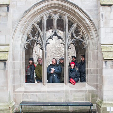 A small group of people standing in the Cobb Gate at the University of Chicago.