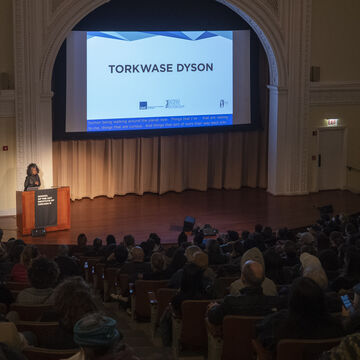 The audience is watching a Torkwase Dyson talk.