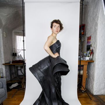 An image of Grace Duval wearing a black dress that she made.