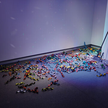 A large pile of multicolored confetti made of stone on the floor. 