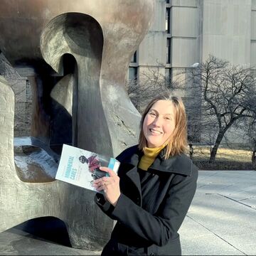 Mechtild Wildrich poses with her new book in front of Henry Moore's Nuclear Energy (installed 1967) at the University of Chicago Campus.