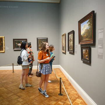 A small group of students looking at art in The Art Institute of Chicago museum.
