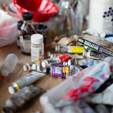 Tubes of paint spread out on a table