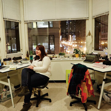 A student sitting in their dorm room. 