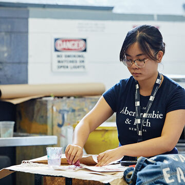 A person working on a project on a large studio.