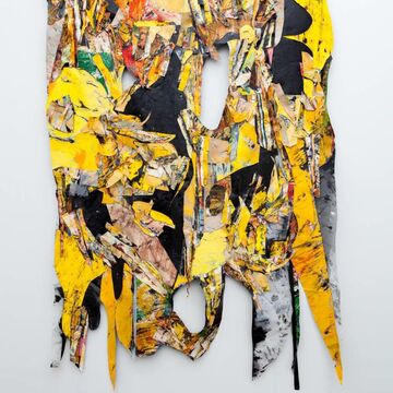 A large textile piece of art with oil painted skins layered on top of fabric using colors like yellow, green, orange and black.