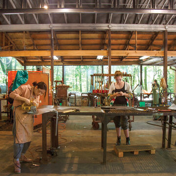 Students working in a metal shop at Oxbow