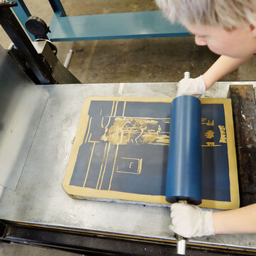A student works on a print piece