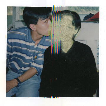 An image of a person kissing the cheek of a heavily distorted person