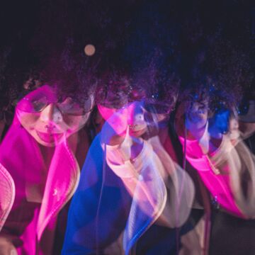 An image of a person with pink and blue lights. 