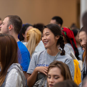 Student smiling amongst a larger group.