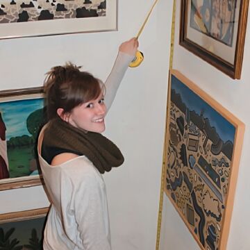 Emily Weevers measuring a wall at the Roger Brown house